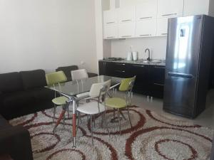 a kitchen with a table and chairs and a refrigerator at Apartament in the centre batumi in Batumi