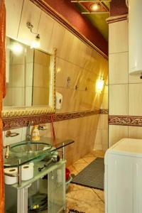 a bathroom with a sink and a mirror at Dali Apartments in Skopje +27 photos