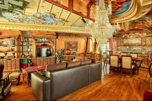 a living room filled with furniture and a chandelier at Dali Apartments in Skopje