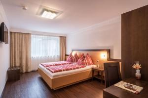 a hotel room with a bed and a window at Apartment Mozart in Mayrhofen