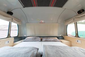 A bed or beds in a room at Bed In Bus