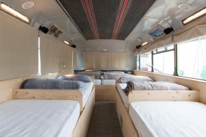 A bed or beds in a room at Bed In Bus