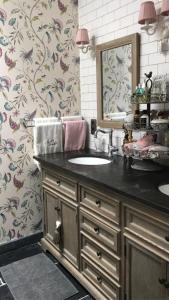 a bathroom with a sink and a mirror at Guestsuite Lady Anna Bruges in Bruges