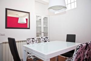 a dining room with a white table and chairs at Viale Trastevere 108 in Rome