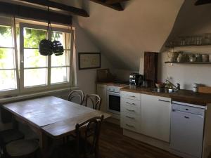 a kitchen with a wooden table and a kitchen with a sink at Alte Donau in Vienna