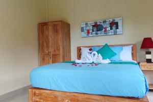 Postel nebo postele na pokoji v ubytování CR Tris Rooms Seminyak