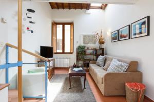 a living room with a couch and a table at Cozy Apartment by the Vatican in Rome