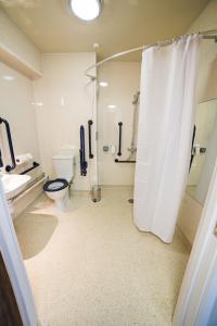 a bathroom with a shower and a toilet and a sink at Red Squirrel, Stevenston by Marston's Inns in Stevenston