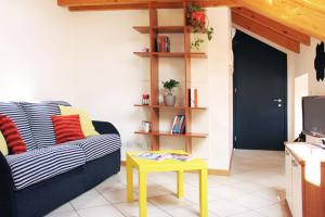 a living room with a couch and a table at "Il Cortile" Apartment in Colico