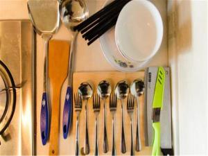 a group of spoons and spatulas in a drawer at Xi'an Helen Apartment in Xi'an