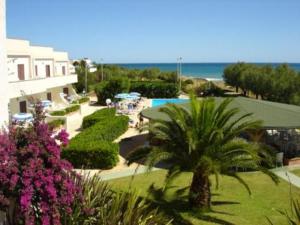 a view of a resort with a pool and a palm tree at Residence Club Barbara in Ostuni