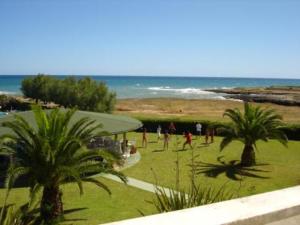 a group of people playing soccer on the beach at Residence Club Barbara in Ostuni