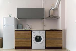 a kitchen with a washing machine and a refrigerator at Hayat Palas in Erzincan