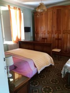 a bedroom with a large bed and wooden cabinets at IL PRINCIPINO B&B in Massa +4 photos