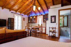 a living room with a table and a dining room at Villa Panorea in Yénion