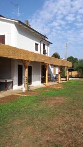 a large white house with a wooden roof at IL PRINCIPINO B&B in Massa