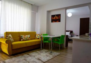 a living room with a yellow couch and a table at Hayat Palas in Erzincan