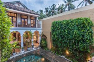 an exterior view of a house with a swimming pool at Thambili House Galle Fort by Edwards Collection in Galle