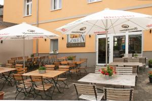 an outdoor patio with tables and chairs and umbrellas at Hotel Restaurant Nassauer Löwen in Nassau