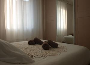 - un lit blanc avec deux beignets au-dessus dans l'établissement Apartamento Tu Sitio, à Pampelune