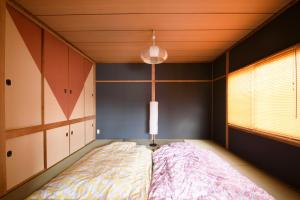 Tempat tidur dalam kamar di HDO Sumikawa Villa