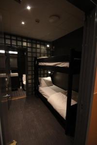 two bunk beds in a room with a bathroom at Stockholm Inn Hotell in Stockholm
