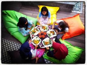 a group of people sitting around a table eating food at The Patio Yogya in Yogyakarta