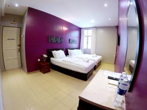 Postel nebo postele na pokoji v ubytování JV Hotel @ Bandar Tasek Mutiara