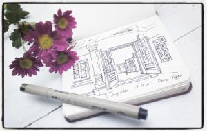 a pen sitting next to a drawing of a building at The Patio Yogya in Yogyakarta
