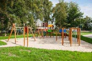 a playground in a park with a swing set at Apartament Sun & Sand Polanki in Kołobrzeg
