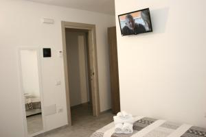 a room with a bed with a picture on the wall at Il Borgo in Castelsardo