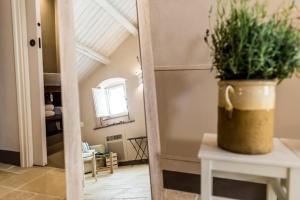 a potted plant sitting on a table in a hallway at Borgo San Gaetano in Bernalda