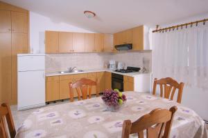 una cocina con una mesa con un bol de fruta. en Apartments Daniela en Trogir