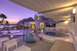 a villa with a swimming pool and a resort at Kalypso Studios in Myrties