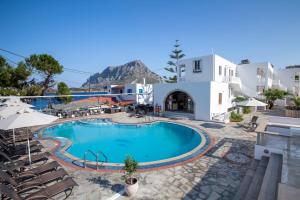 
a large swimming pool with a patio area at Kalypso Studios in Myrties
