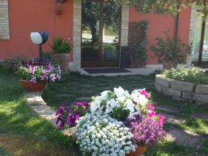 a garden of flowers in front of a house at Agriturismo Il Borgo Degli Ulivi in Roseto degli Abruzzi