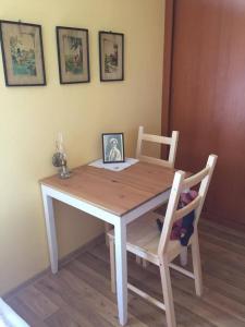 a wooden table and chairs with a picture on it at Rekreační dům u Marušky in Božanov +22 photos