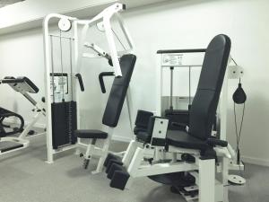 a gym with two tread machines and a mirror at Kysthotellet in Grenå
