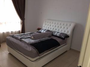 a white bed with pillows on it in a bedroom at Homestay As SyifaMuslimOnly Changlun in Changlun