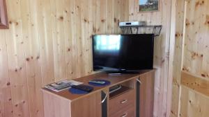 a flat screen tv sitting on top of a wooden cabinet at Haus Kerschbaumer in Rangersdorf