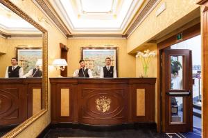 a group of men in a courtroom with a mirror at Hotel Manfredi Suite In Rome in Rome
