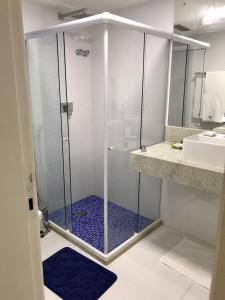 y baño con ducha y puerta de cristal. en Ondina Apart Hotel 621 en Salvador