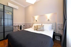 een slaapkamer met een groot bed met witte lakens en kussens bij Markiz Luxury Apartments in Zagreb