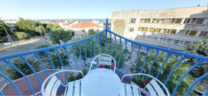 a balcony with a blue railing and a view of a city at Family Hotel Four Seasons Tsarevo in Tsarevo