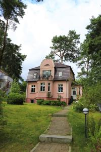 a pink house with a gambrel roof at Fahrradpension am Weg nach Kopenhagen in Fürstenberg-Havel