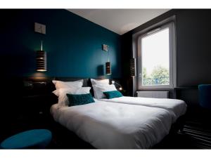 Postel nebo postele na pokoji v ubytování Hotel Restaurant Les Capucins