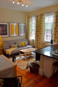 a living room with a couch and a table at Gorgeous 2 bed best North End location w parking in Boston