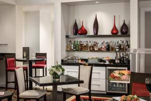 a restaurant with tables and chairs and vases on the wall at Inn On Fifth in Naples