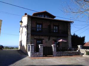 a large brick house with a balcony at Casa Albertino in El Tejo