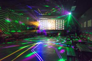a nightclub with green and purple lights on the floor at Aquamarine Resort in Akshi +156 photos